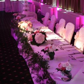 fwthumbTop table vases linked with asparagus fern along full length.jpg